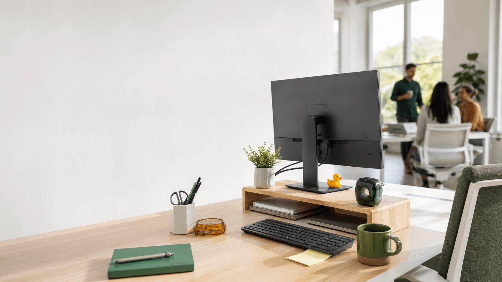 A bright office desk with unexpected items placed around the monitor and keyboard